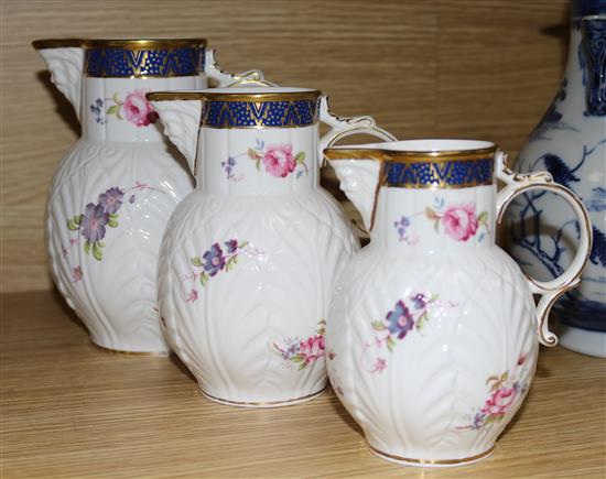 A set of three Coalport Caughley mask head jugs, graduated set, largest 17cm